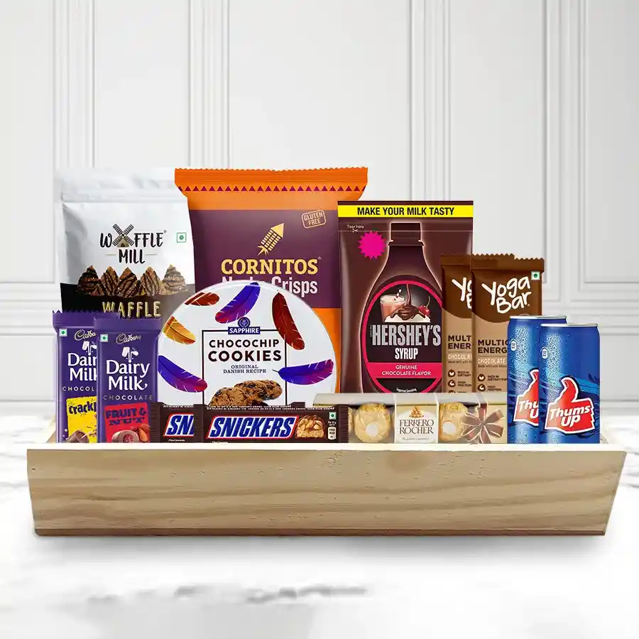 Ideal Gourmet & Chocolate Choice Xmas Hamper featuring chocolates, cookies, nachos, drinks, and more on a wooden tray.