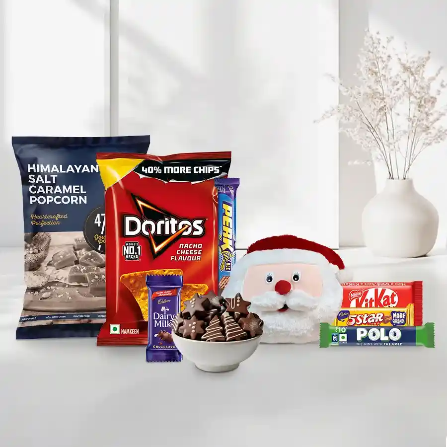 Grand Xmas Theme Chocolate Hamper for Kids featuring festive treats like chocolates, popcorn, and snacks alongside a Santa Claus face cushion