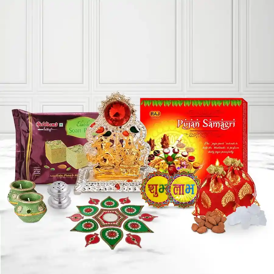 Splendid Pooja N Decor Essential Gift Box for Diwali featuring Ganesh Lakshmi Mandap, Puja Samagri Set, Matki Wax Diyas, Acrylic Rangoli Set, Subh Labh Sticker, Doop Box, Haldiram Soan Papdi, and Almond & Mishri Potli, all neatly arranged in a festive gift box.