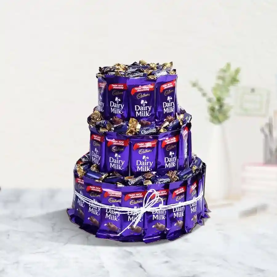Triple layer arrangement of Cadbury chocolates including Dairy Milk bars and Chocolairs Gold, beautifully presented for Valentine's Day.
