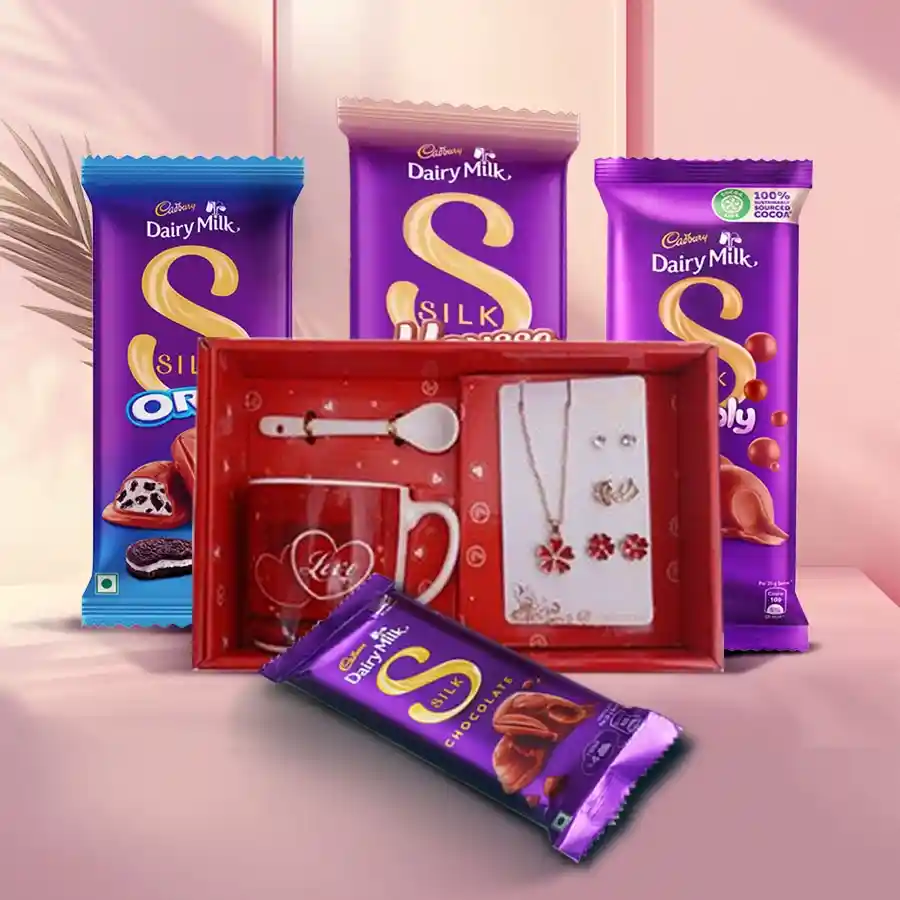 Love mug, jewelry set, and assortment of Cadbury chocolates in a romantic display