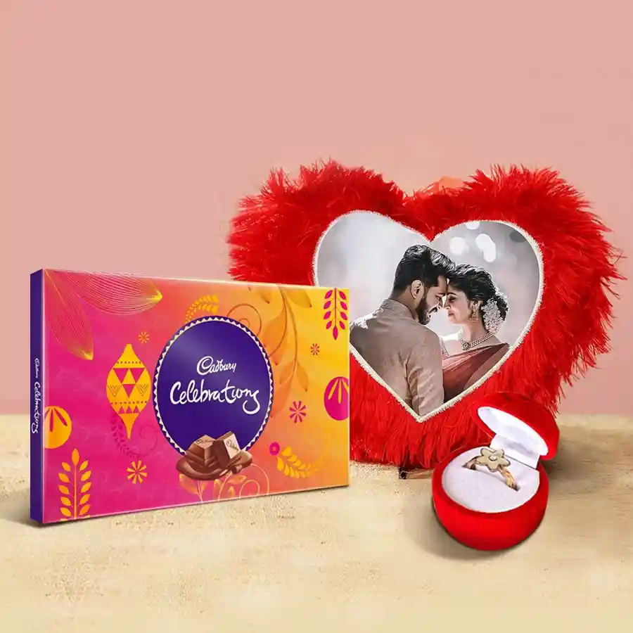 Valentine's Day gift combo featuring a heart-shaped cushion, faux rose with ring, and Cadbury Celebrations chocolates
