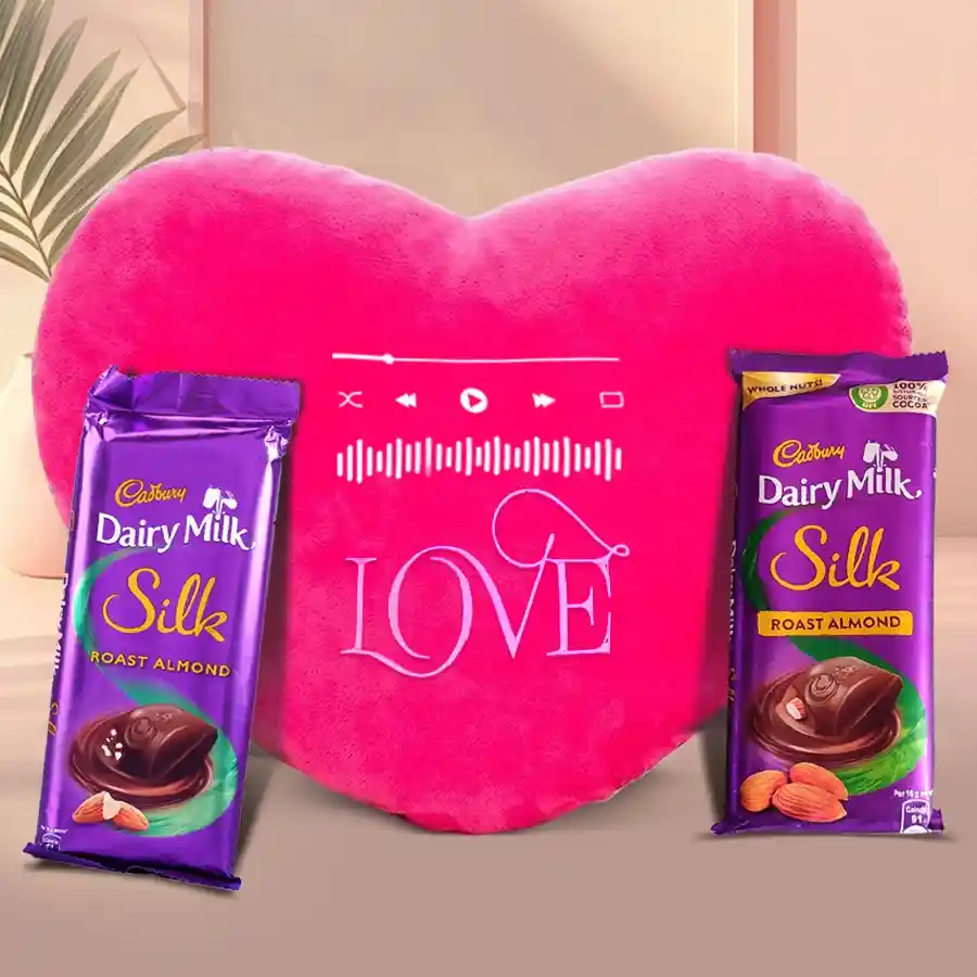 Heart-shaped musical cushion with Cadbury Dairy Milk Silk chocolates for Valentine's Day gift.