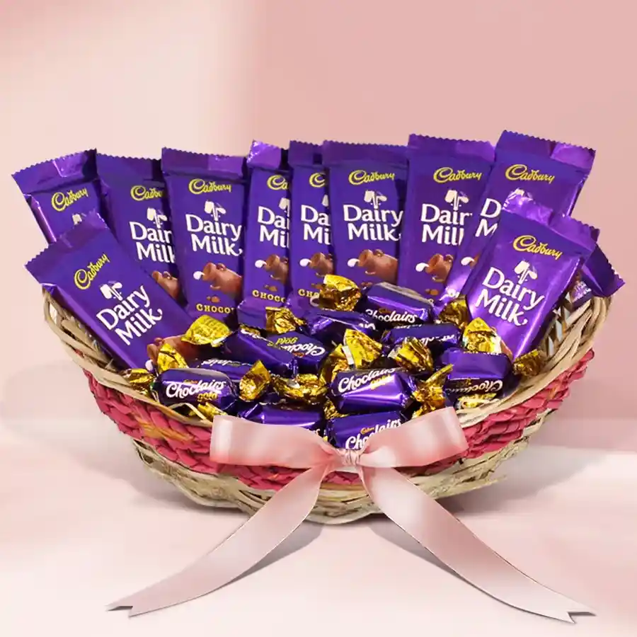 A beautifully arranged cane basket filled with 12 Cadbury Dairy Milk bars and 30 Cadbury Chocolairs Gold candies, designed for a romantic Valentine's gift.