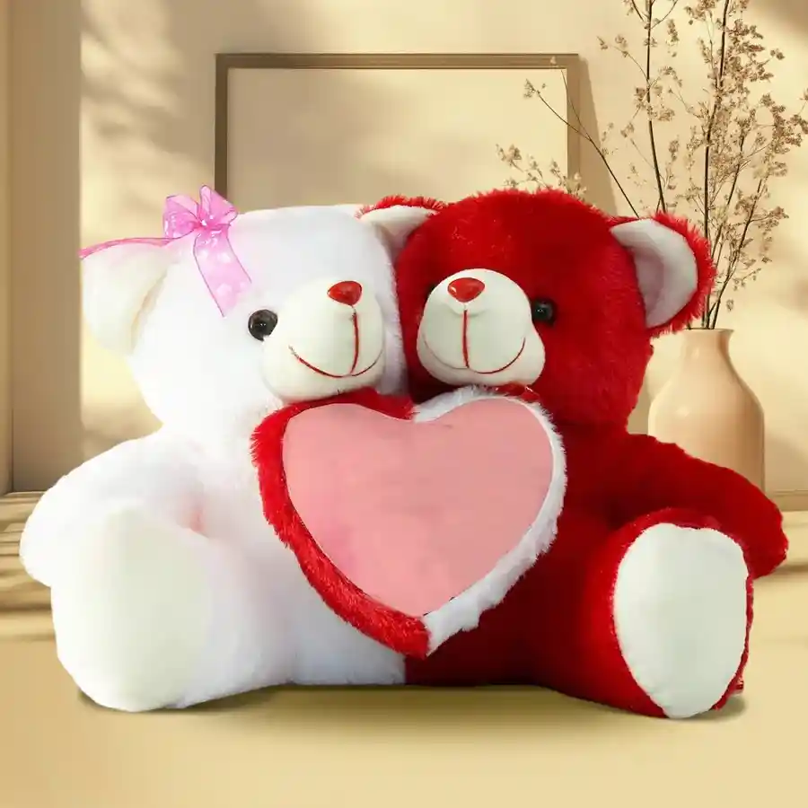Two red and white plush teddy bears holding a vibrant red heart, symbolizing love and affection for Teddy Day.