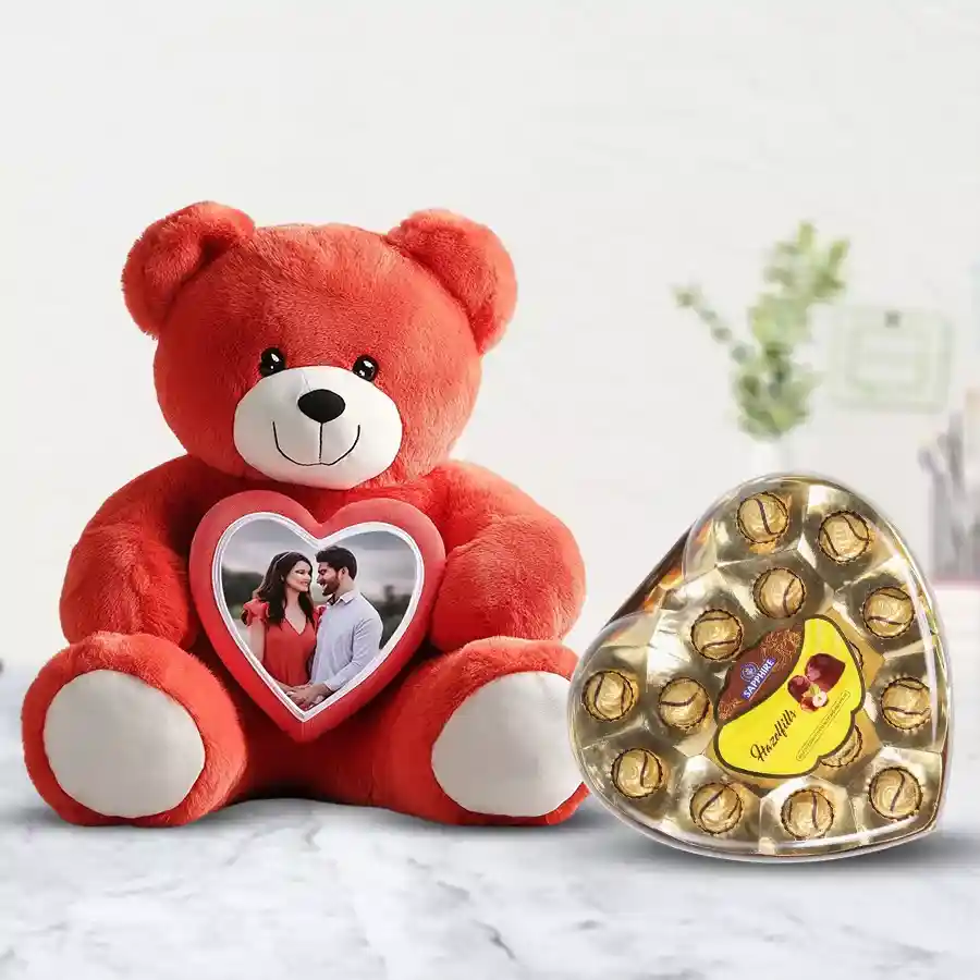 Enigmatic Personalized Photo Teddy next to a heart-shaped box of Sapphire Hazelfills chocolates