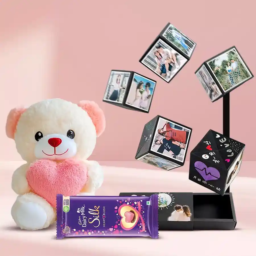 Dashing Magic Pop-Up Box containing personalized photos, a teddy bear with a heart, and Cadbury Silk Heart Blush chocolate.