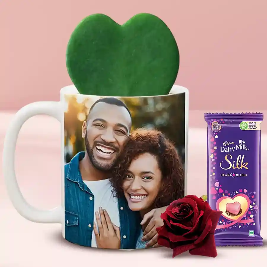 Amazing Hoya Heart Plant in a personalized photo coffee mug next to a Red Velvet Rose and a box of Cadbury Silk Heart Blush Chocolate.