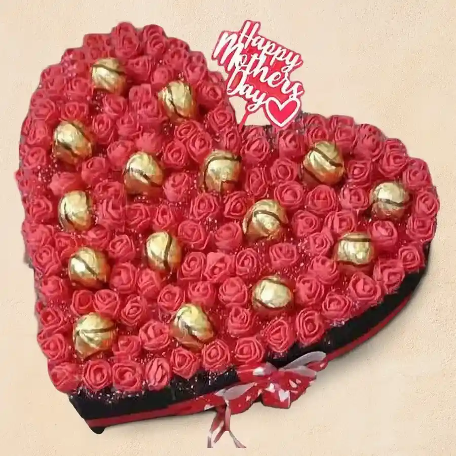 16-piece arrangement of Sapphire Hazelfills Chocolate and artificial roses in a heart shape, topped with a Mother's Day topper, showcasing rich sapphire and cozy chocolate hues.