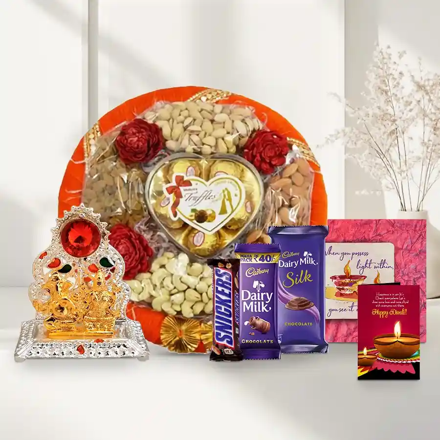 Fabulous Gift Tray of Chocolates and Nuts including cashews, almonds, pistachios, Cadbury and Snickers chocolates, a Ganesh Laxmi Mandap, a handmade fridge magnet, and a Diwali card on a fancy round tray