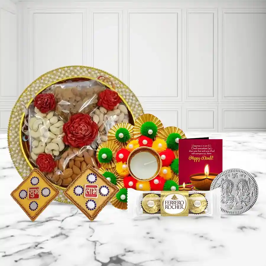 Happiness Overloaded Dry Fruits Tray featuring premium cashews, raisins, almonds, pistachios, Ferrero Rocher chocolates, decorative Diya, Shubh Labh wall sticker set, silver-plated coin, and Diwali wishing card.