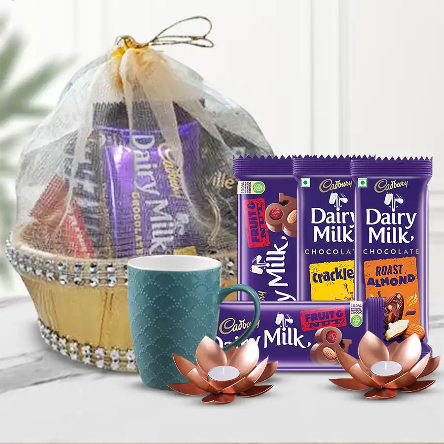 Chocolaty treat hamper for Diwali featuring a decorative basket filled with Cadbury chocolates, a stylish coffee mug, and Lotus tea light candle holders.