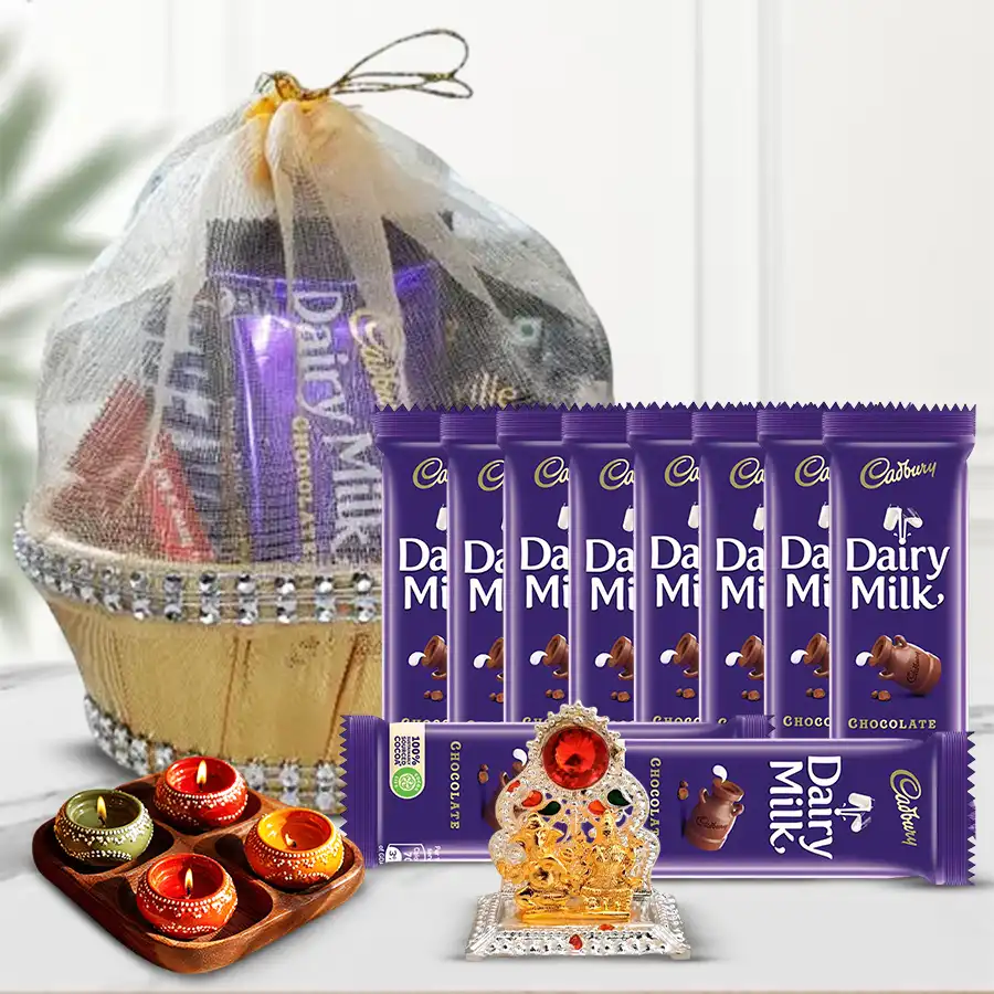 Diwali Chocolate Muses gift combo featuring Cadbury Dairy Milk chocolate bars, decorative wax diyas, a Ganesh Laxmi mandap, and a stylish basket