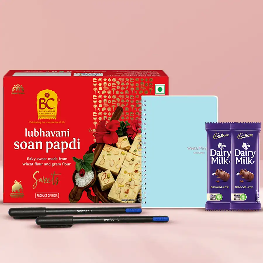 Supreme Sweets Feast gift hamper featuring Soan Papdi, Cadbury Dairy Milk bars, Pentonic ball pens, and a stylish Planner-Note diary, beautifully arranged for Deepavali celebration.