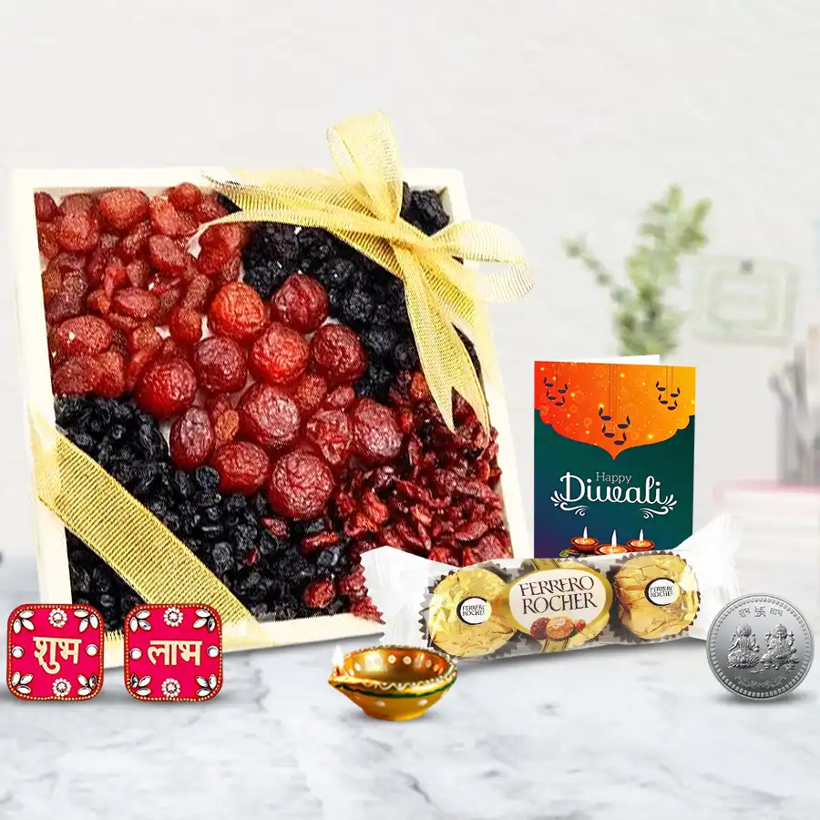 Diwali gift hamper featuring a wooden tray with fresh berries, Ferrero Rocher chocolates, a fancy diya, Shubh Labh wall sticker set, silver-plated coin, and a Diwali wishing card.