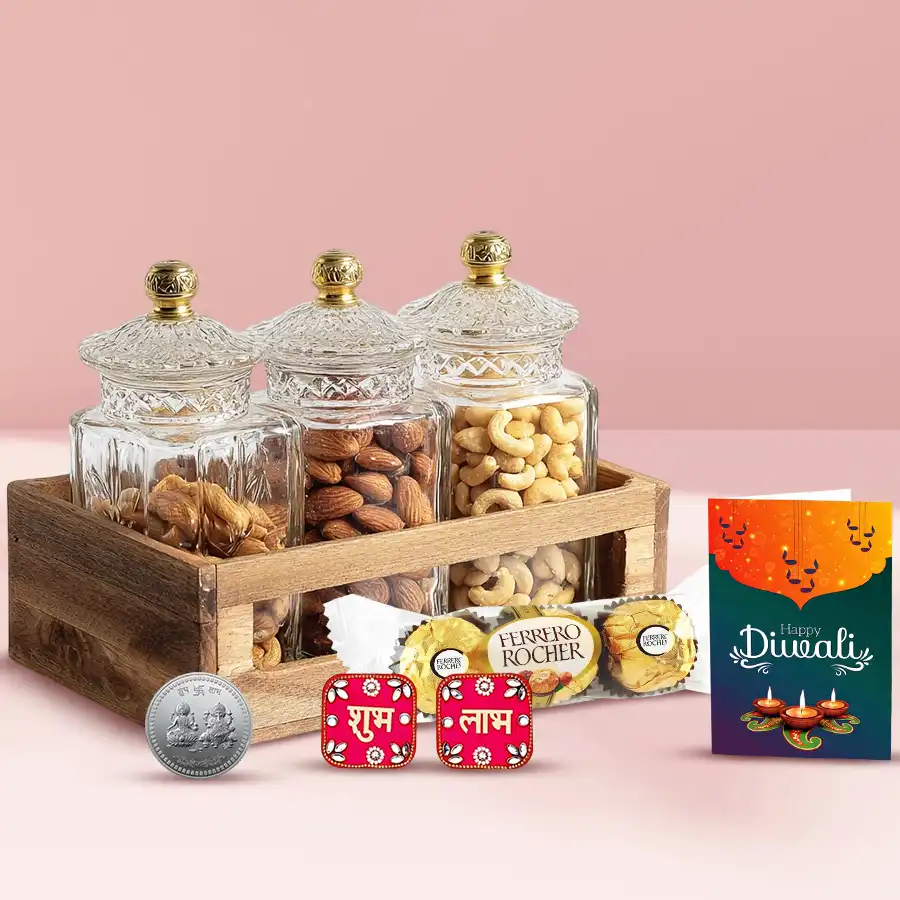 Family Pampering Gift Hamper featuring a wooden tray with glass jars of cashews, almonds, raisins, Ferrero Rocher chocolates, a fancy diya, Shubh Labh wall stickers, a silver-plated coin, and a Diwali greetings card.