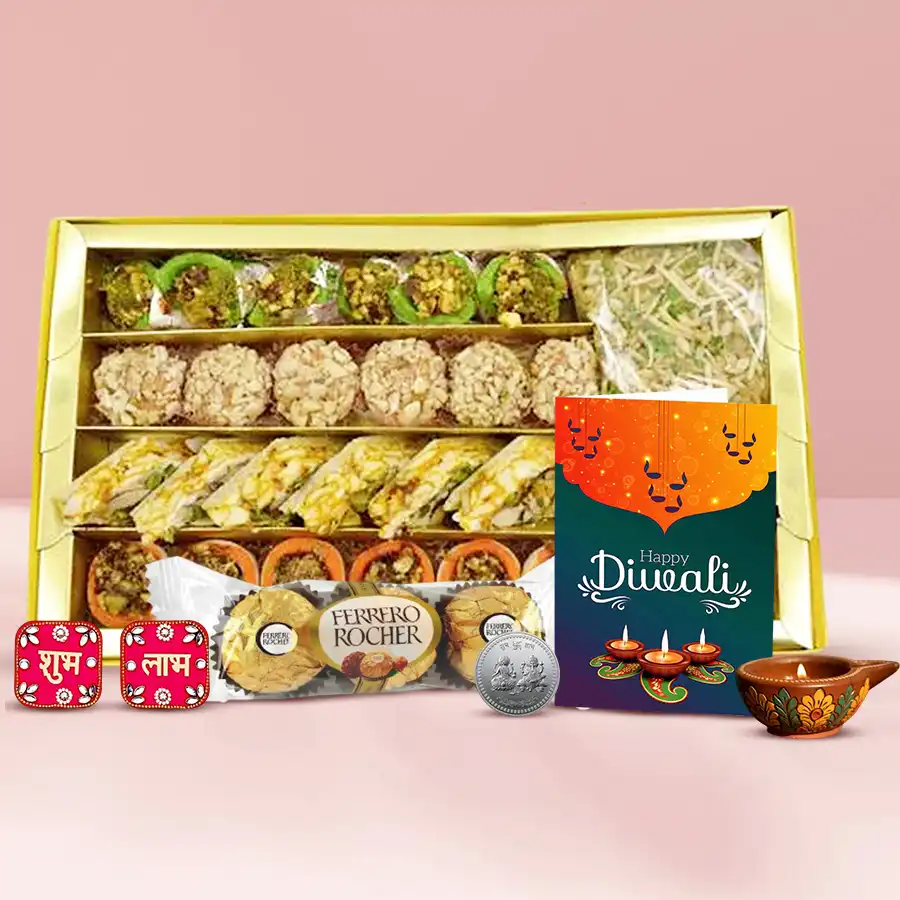 Taste of Diwali Gift Hamper featuring assorted sweets, Ferrero Rocher, a diya, festive wall stickers, a Ganesh Lakshmi coin, and a wishing card.