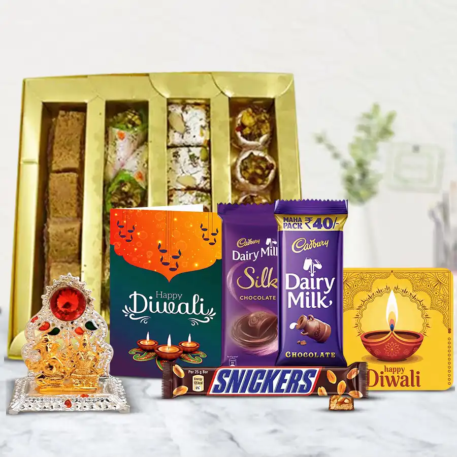 Delightful Diwali Gift Hamper featuring mixed sweets, Cadbury Dairy Milk, Snickers, Ganesh-Laxmi Mandap, handmade fridge magnet, and a Diwali card