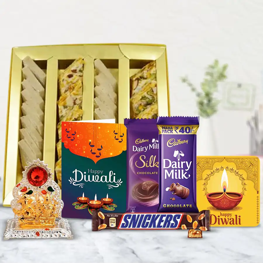 Ever Delightful Diwali Gift Box featuring dry fruits, Kaju Barfi, Cadbury chocolates, Snickers, a Ganesh Laxmi Mandap, a handmade fridge magnet, and a festive card.