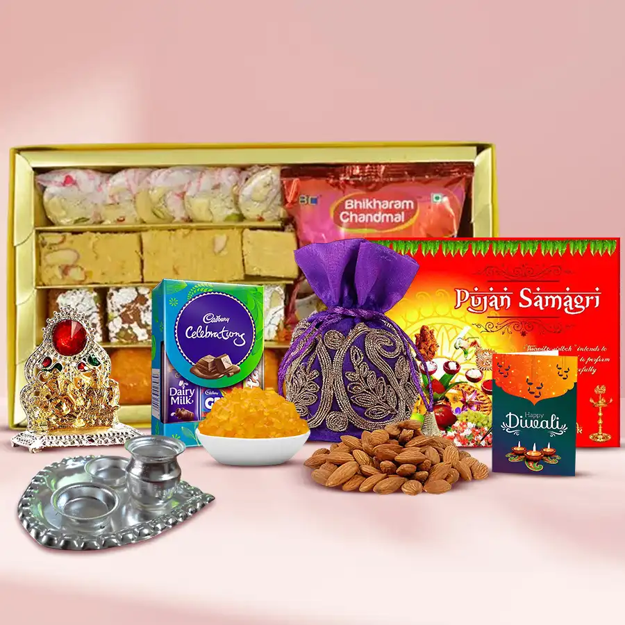 Special Sweets Assortment Gift Hamper with Kesar Laddoo, Soan Papdi, Bhujia, Cadbury Dairy Milk, Ganesh Lakshmi Mandap, almond potli, silver paan-shaped pooja thali, and pooja samagri, all beautifully arranged for Diwali celebration.