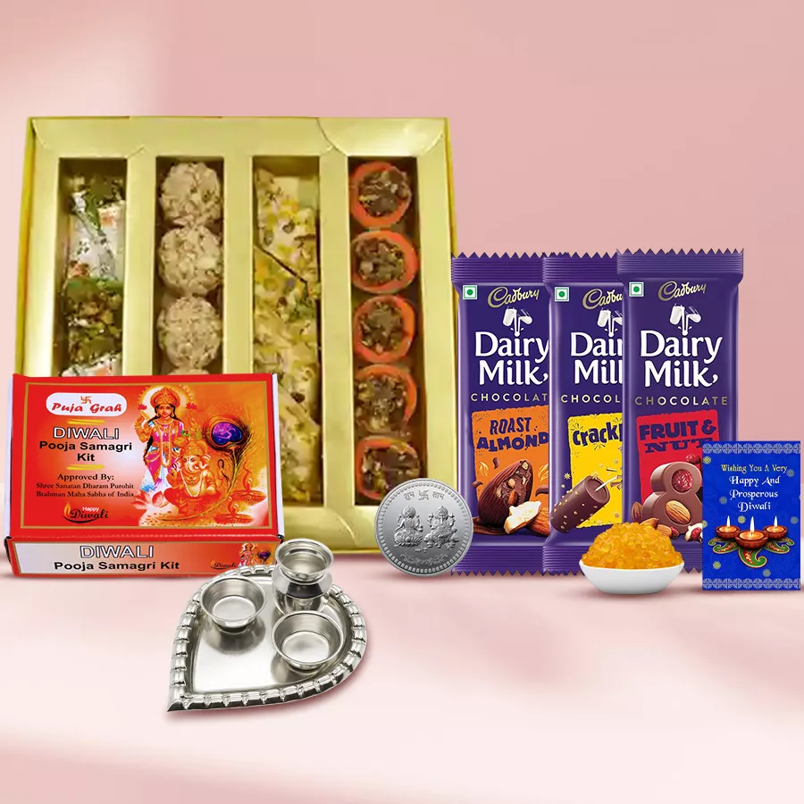 Galore of Happiness Diwali Treat bundle featuring Kaju sweets, Cadbury Dairy Milk chocolates, silver paan-shaped pooja thali, Ganesh-Laxmi coin, pooja samagri, Kesaria Misri, and a Diwali card.