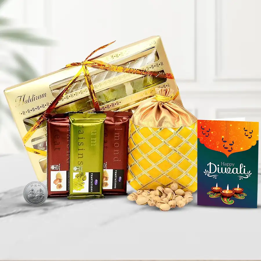 Delicious Festive Sweets Diwali Hamper featuring assorted sweets, cashew potli, silver-plated coin, Cadbury Temptation bars, and a Diwali card