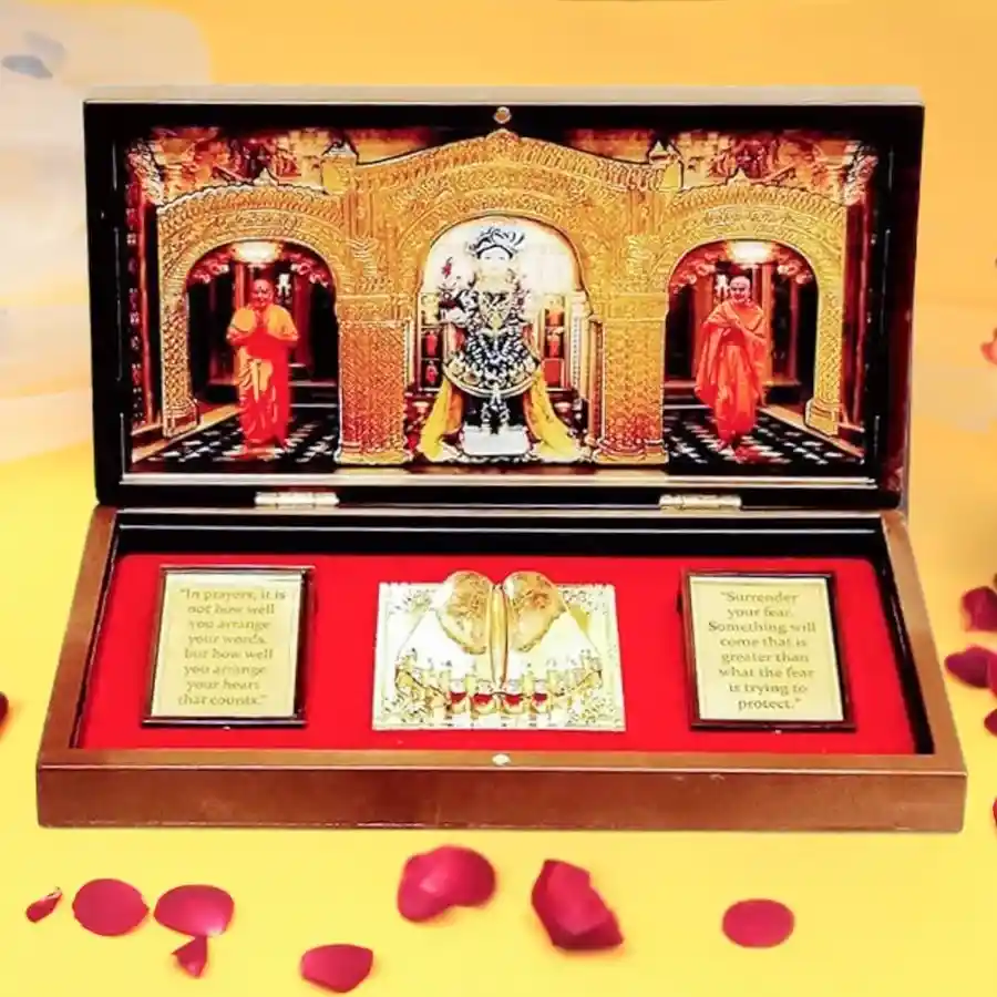 Auspicious Swaminarayan photo frame with Charan Paduka in a gold-plated finish and multicolor design, displayed on a tabletop.