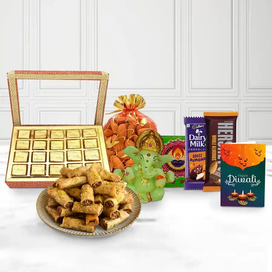 Famous Roll Baklava N Chocolaty Splash gift box with Roll Baklava, Cadbury and Hershey’s almond chocolate bars, crunchy almond bites, Ganesh idol, almond potli, handmade fridge magnet, and a Diwali card