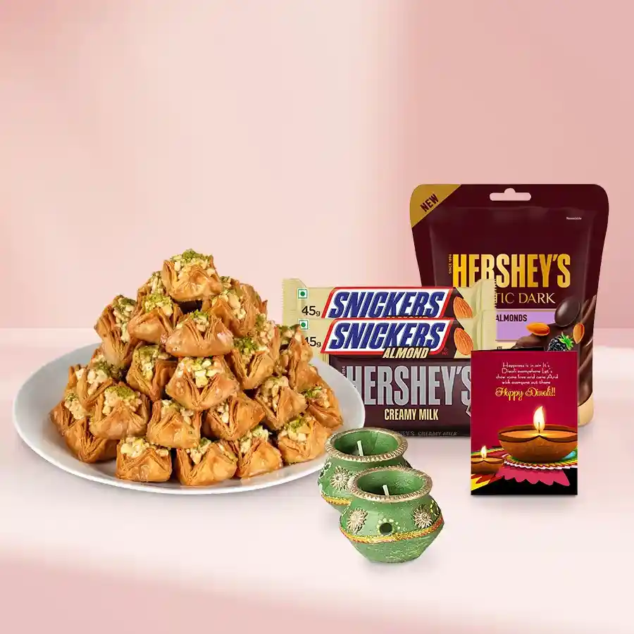 Angelic Pyramid Baklava and Choco Fun festive gift basket with layers of baklava, decorated wax diyas, Hershey's and Snickers chocolates, premium chocolate-coated dried fruits, almond bars, and a Diwali card.