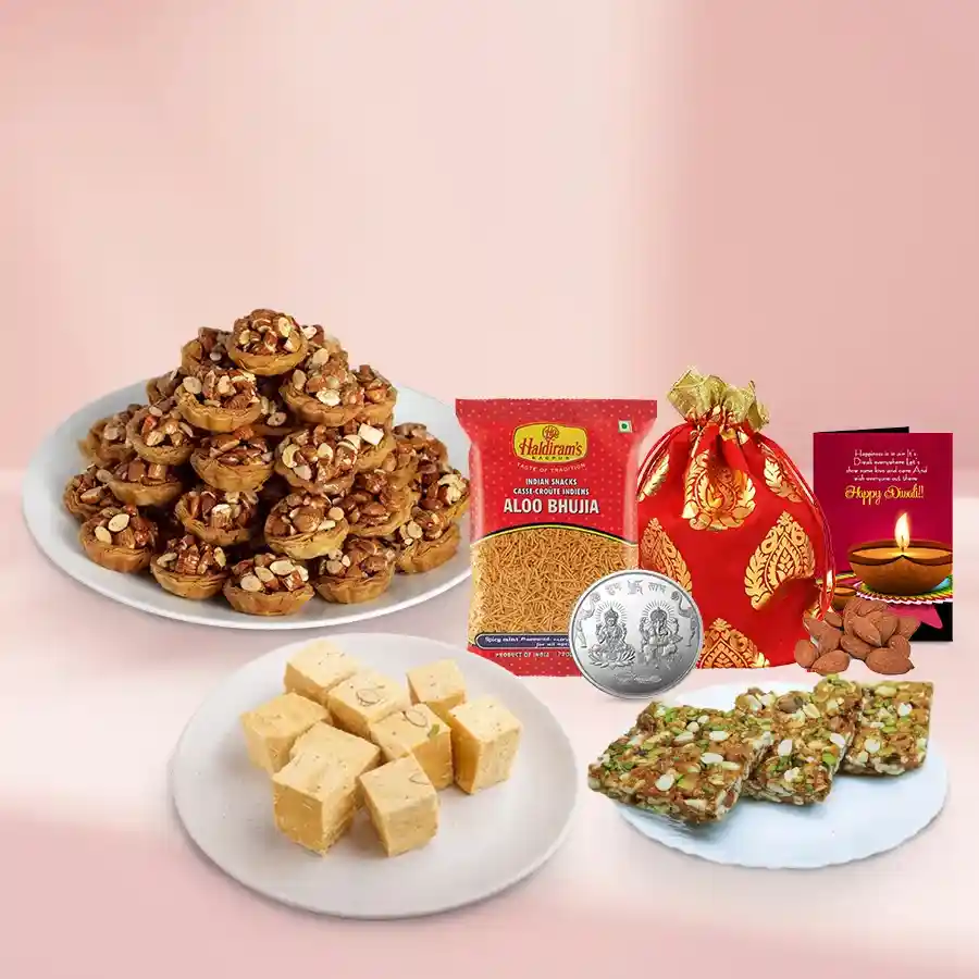 Enchanting Tart Baklava Basket with Tart Baklava, Soan Papdi, Bhujiya, Dry Fruit Chiki, almonds, Ganesh Lakshmi coin, and a Diwali card.