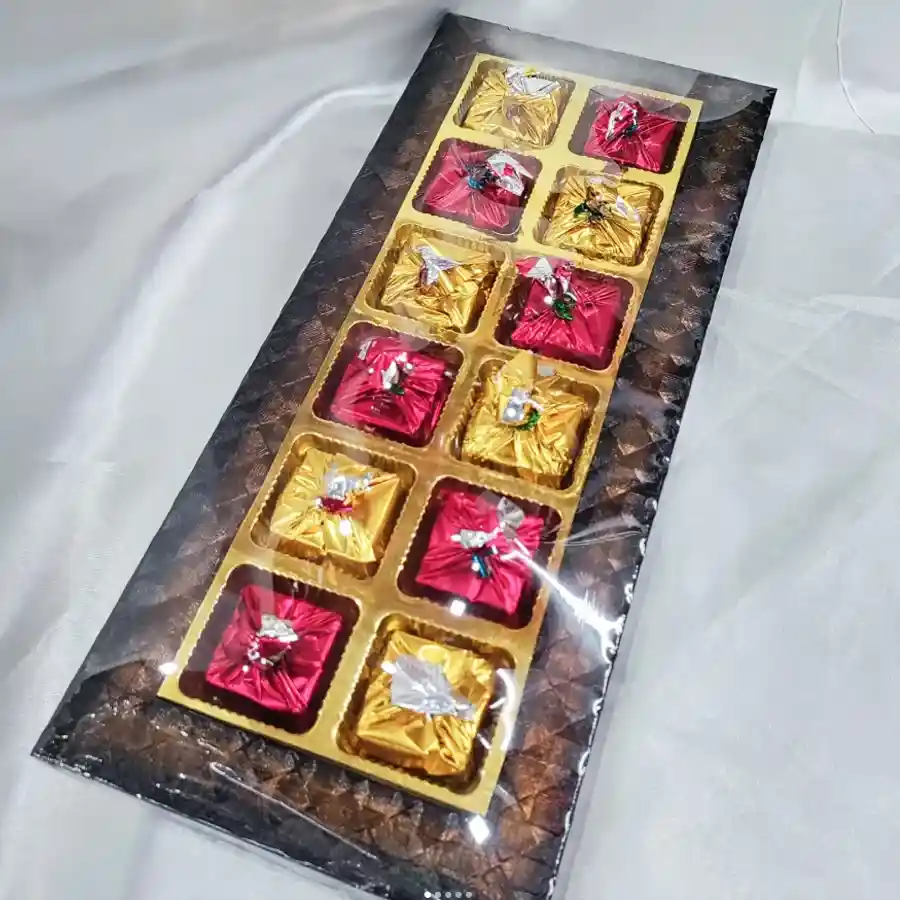 Wooden tray featuring 12 rich dark chocolates and 2 golden diyas, perfect for Deepavali celebrations.