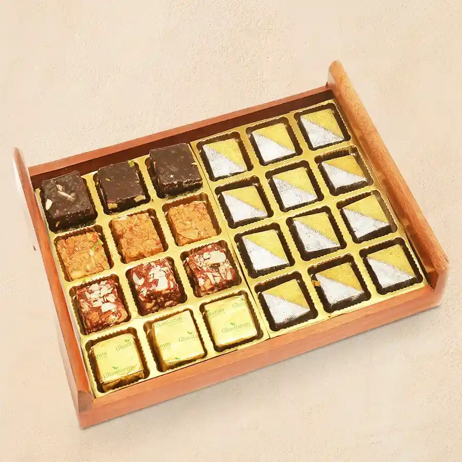 Handmade chocolate and golden diya duo in a rustic wooden tray for Deepavali celebrations