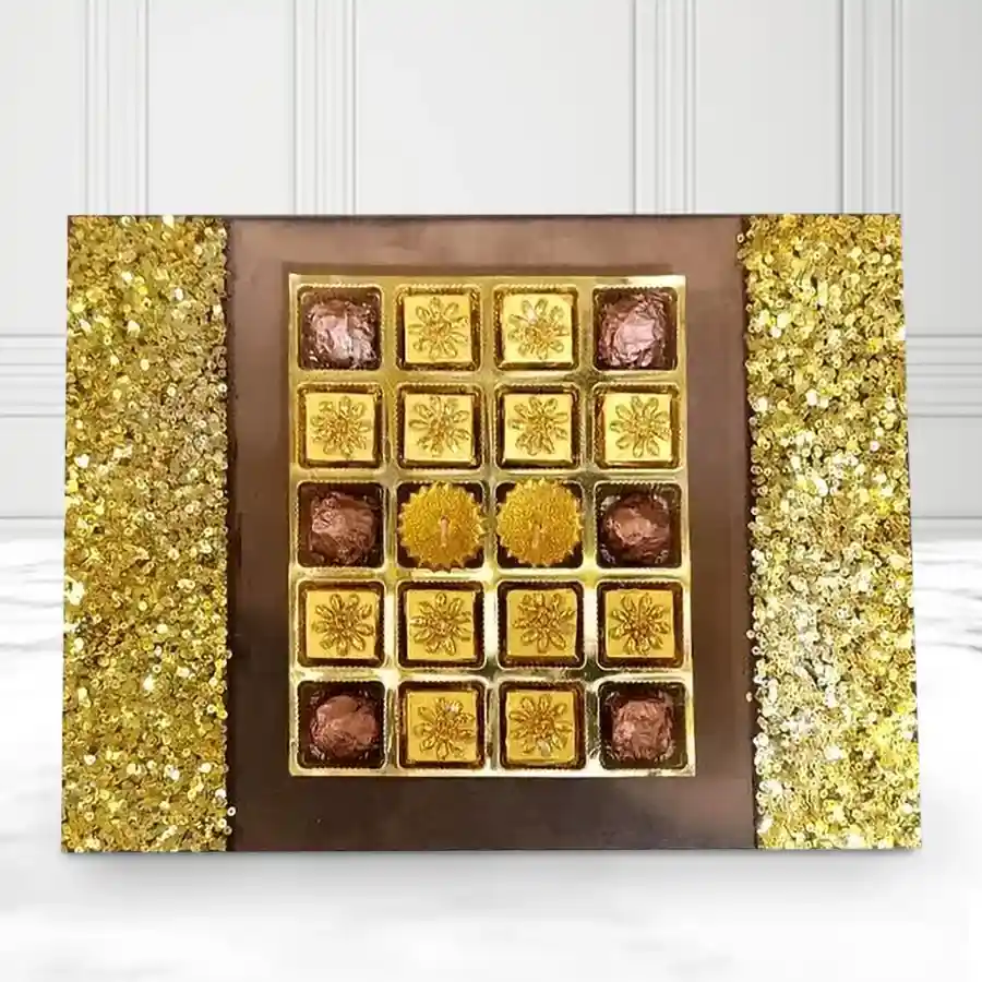 Enchanted wooden tray filled with 18 handmade dark chocolates and 2 golden diyas, perfect for Deepavali celebrations