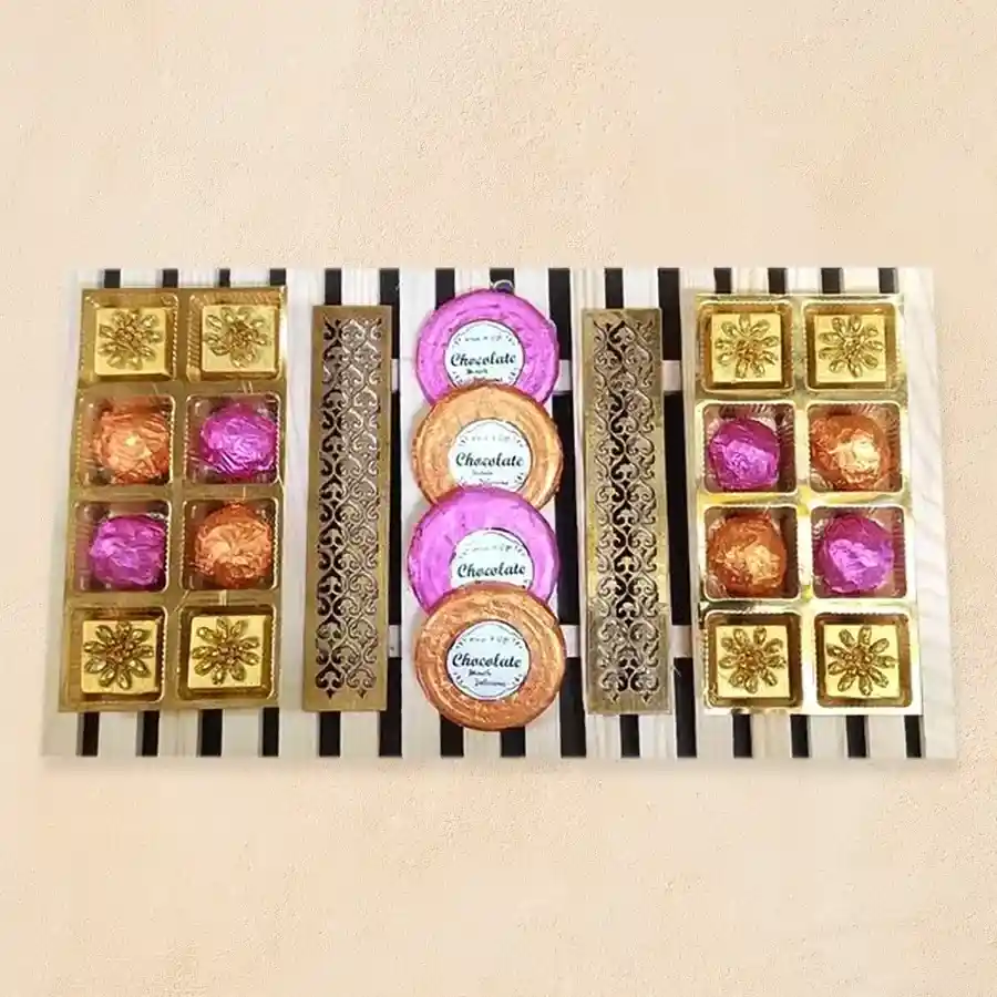 Handcrafted dark chocolates and Nilgiri cookies arranged in a wooden tray for a festive gift set.