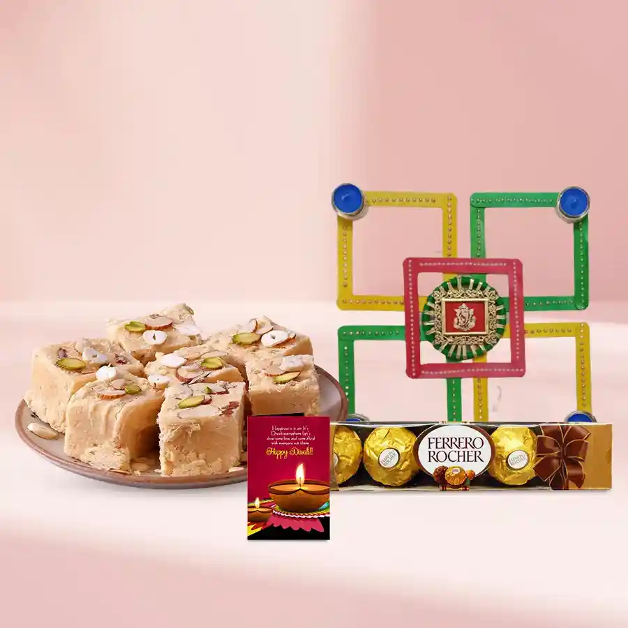 Diwali Bliss Goodies Box featuring Soan Papdi, a designer candle, a traditional diya, vibrant rangoli, Ferrero Rocher chocolates, and a Diwali greeting card