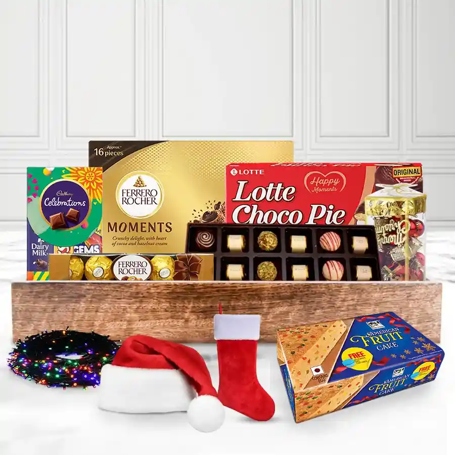 Premium Xmas Cake and Chocolate Delight Gift Hamper featuring American fruit cake, Ferrero Rocher, Cadbury chocolates, Lotte Chocopie, and handmade chocolates, elegantly arranged in a reusable wooden tray with Christmas decorations.