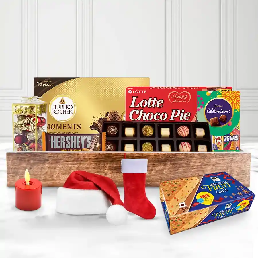 Exquisite X-Mas Cake with assorted chocolates and festive decorations in a wooden tray