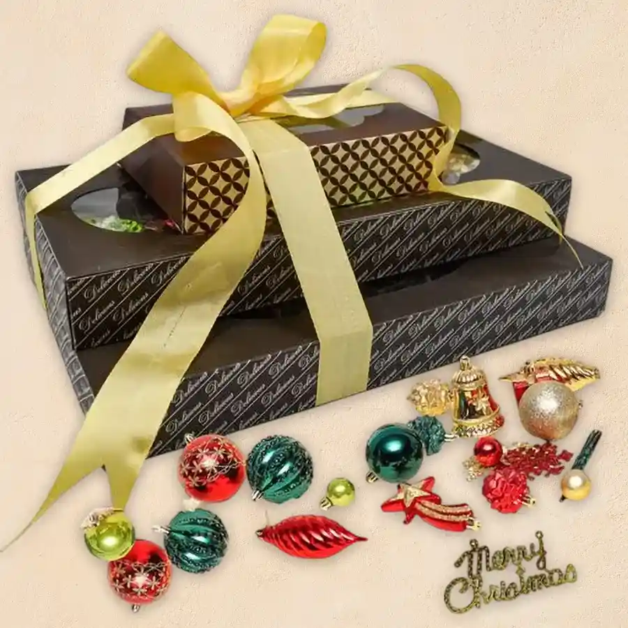 Exotic 3-layer chocolate tower with decorations for Christmas, featuring rum-filled chocolates, nutty dry fruit pieces, and crunchy delights in a festive arrangement.