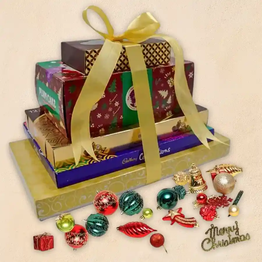 Amazing 5 Layer Christmas Chocolate Tower featuring American Fruit Cake, Ferrero Rocher Moments, Cadbury Celebrations, Luxure Truffles, and Handmade Chocolates with a box of Xmas decorations.