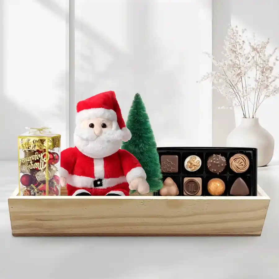 Handmade chocolates with Santa figure and Christmas tree in a reusable wooden gift box