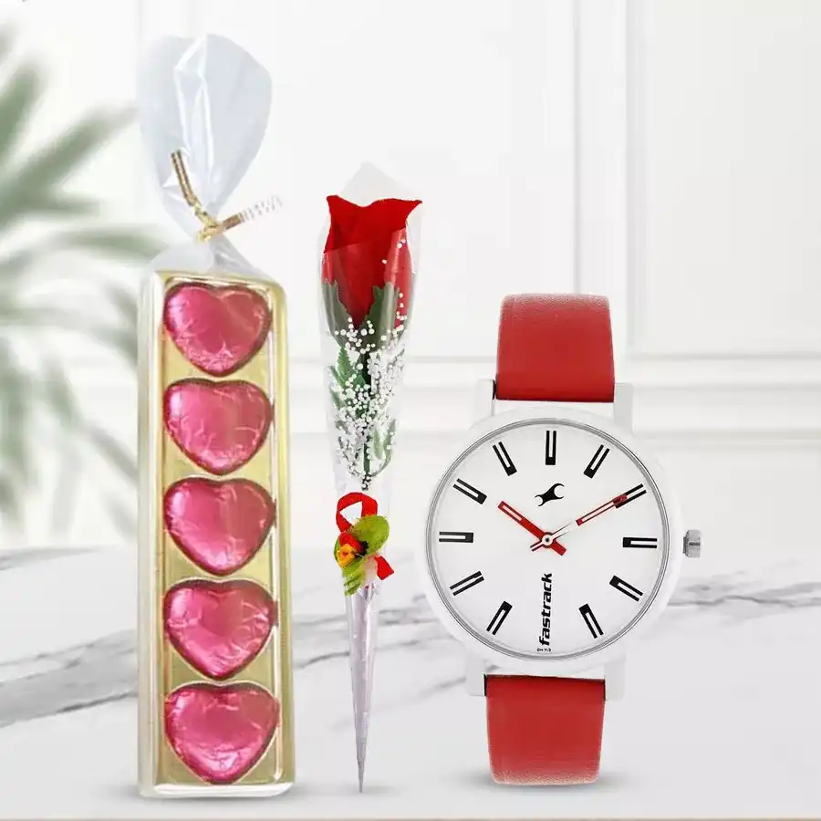 Elegant ladies watch with a white dial, red rose stick, and five heart-shaped chocolates arranged together for Valentine's Day gifting.