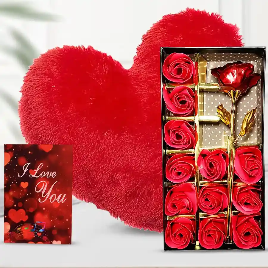Elegant gift set featuring artificial red roses in a flower box, a soft red cushion, and an "I Love You" card.