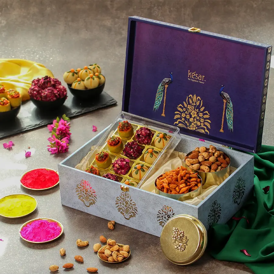 Delectable assorted ladoos and nuts in a premium Holi gift box with a festive greetings card