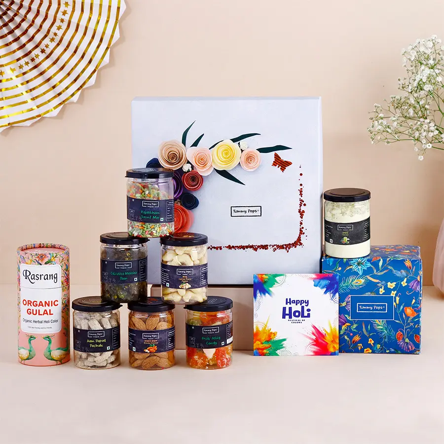 Delicious Assorted Mukhwas with Thandai N Nuts Gift Box featuring colorful gulal, premium dry fruits, and a heartfelt greeting card, all arranged for Holi celebration.