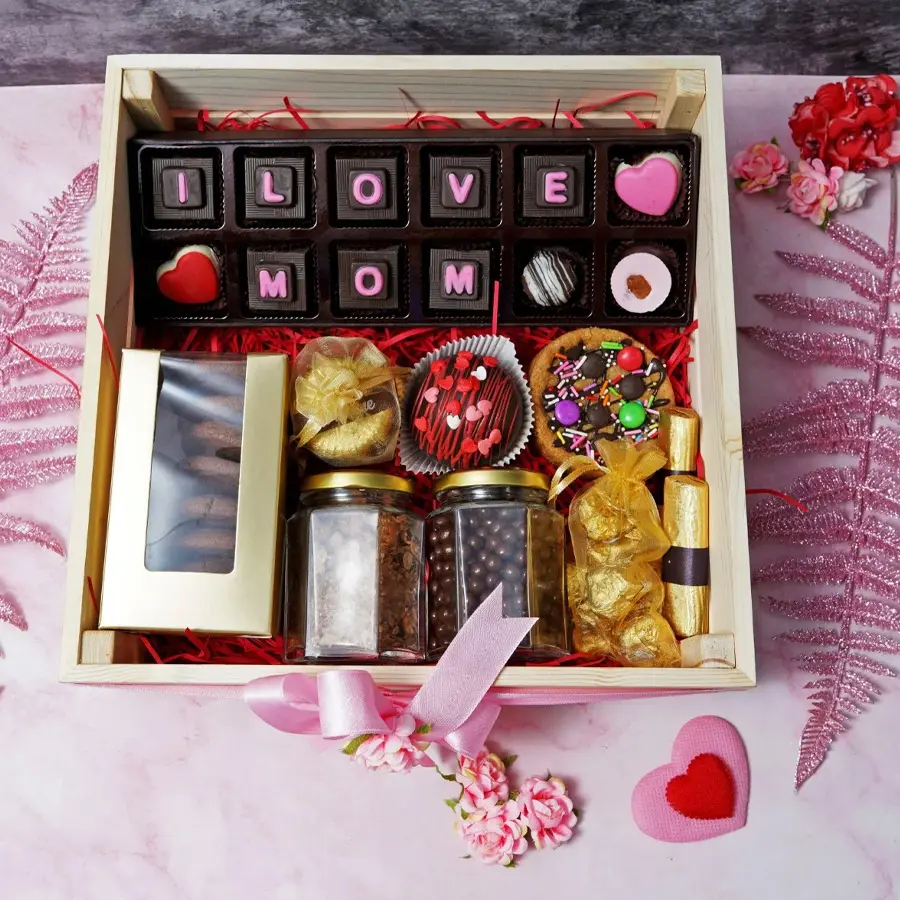 Amazing Choco N Cookie Loaded Hamper for Mom featuring a variety of chocolates, cookies, Florentines, coated raisins, butterscotch, chocolate logs, almond rocks, pizzokie cookie, and a hot chocolate bomb