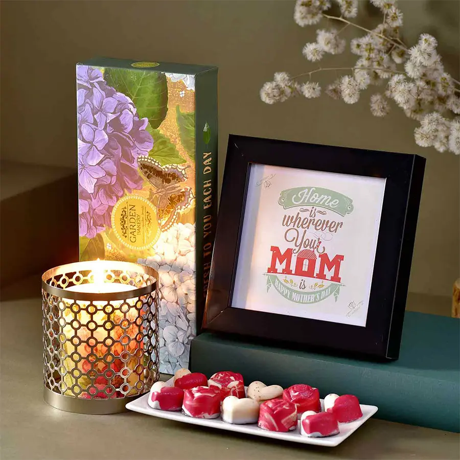 Adoring Moms Day Hamper featuring a MOM Loving Photo Frame, Garden Bakery Chocolate Hamper, scented candle, and perforated tin T-Light Holder.