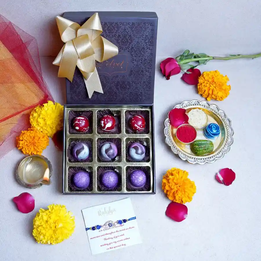 An elegant box containing assorted bon bon chocolates, a beautifully designed rakhi, and a heartfelt greeting card, perfect for celebrating Raksha Bandhan.