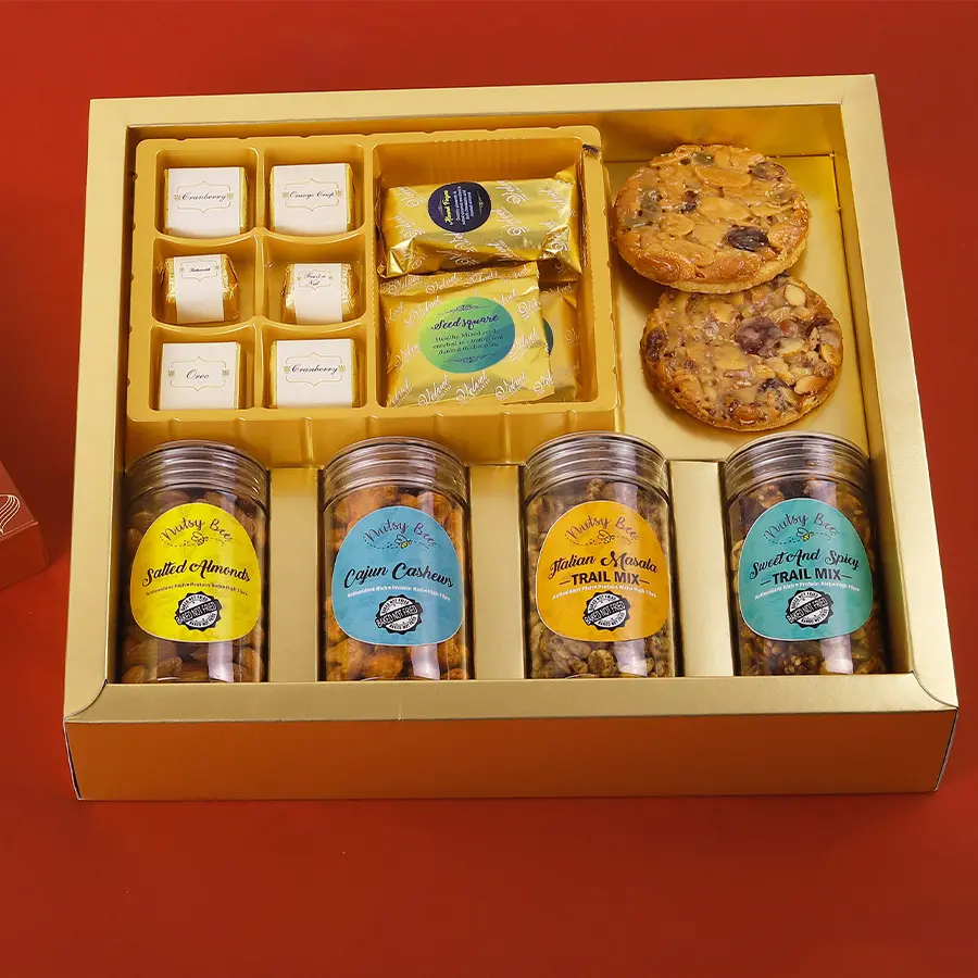 An assortment of chocolates, cookies, and nut mixes in a stylish snack box.