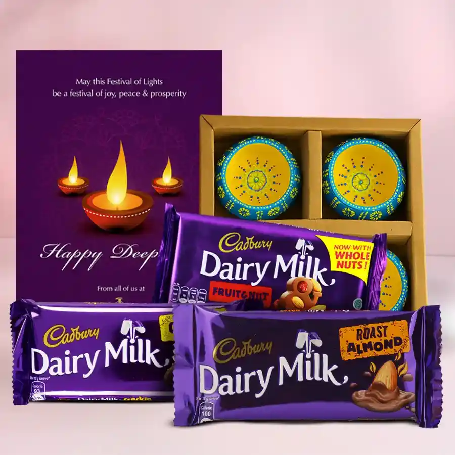 Diwali Chocolate N Diya Bliss Box featuring Cadbury Dairy Milk chocolates, designer clay diyas, and a Happy Diwali card