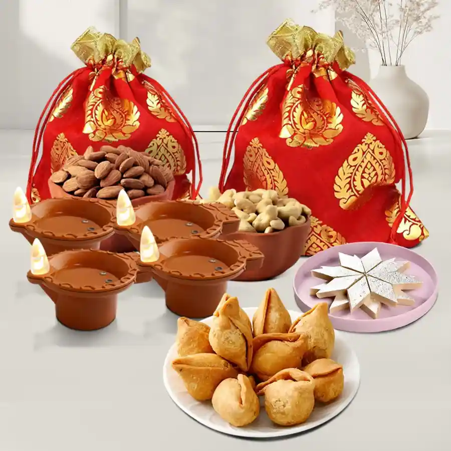 Diwali gift box featuring premium cashews and almonds in potlis, kaju katli, mini samosas, and LED water sensor diyas